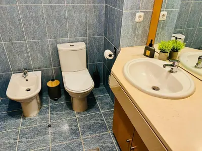 a bathroom with a toilet and a sink at Maria do Mar Apartment in Caniço