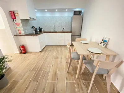 a kitchen and dining room with a table and chairs at Casa do Sol in Sagres
