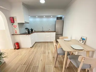 a kitchen and dining room with a table and chairs at Casa do Sol in Sagres