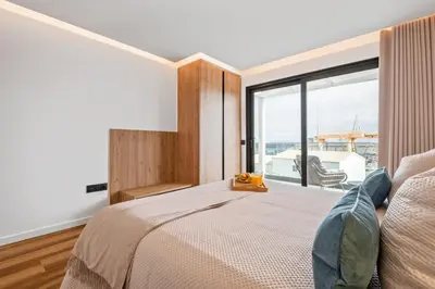 a bedroom with a bed and a large window at Luxury Seafront Escape I in Caniçal