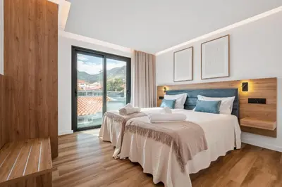 a bedroom with a large bed and a large window at Luxury Seafront Escape I in Caniçal