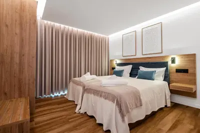 a bedroom with a large bed with blue pillows at Luxury Seafront Escape I in Caniçal