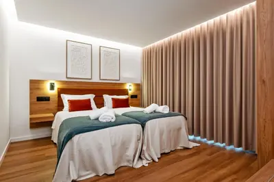a bedroom with a large bed with red pillows at Luxury Seafront Escape II in Caniçal