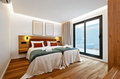 a bedroom with two beds and a large window at Luxury Seafront Escape II in Caniçal