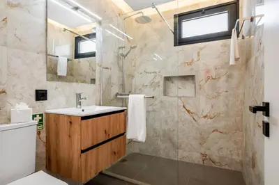 a bathroom with a sink and a shower at Luxury Seafront Escape II in Caniçal