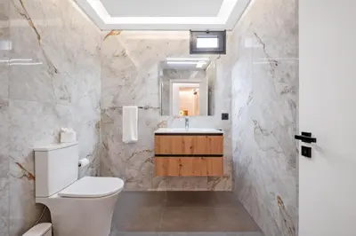 a bathroom with a toilet and a sink at Luxury Seafront Escape II in Caniçal
