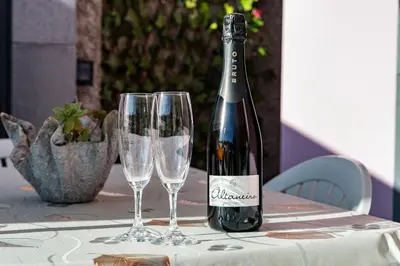 a bottle of wine sitting on a table with two glasses at Mimi Holiday House - Free Parking in Funchal