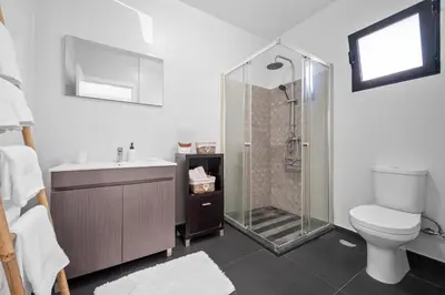 a bathroom with a shower and a toilet and a sink at Mimi Holiday House - Free Parking in Funchal