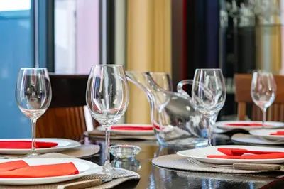 a table with wine glasses and plates on it at Mimi Holiday House - Free Parking in Funchal
