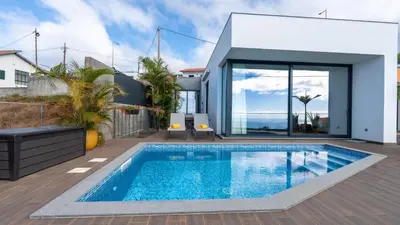 a swimming pool in the backyard of a house at Moonlight Villa by LovelyStay in Estreito da Calheta