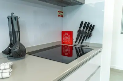 a kitchen counter with utensils on a counter top at Alameda Formosa Varanda Zona Turística Funchal in Funchal