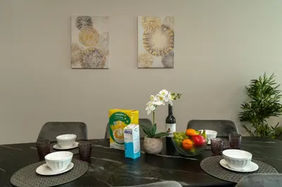 a table with two cups and a bowl of fruit at Alameda Formosa Varanda Zona Turística Funchal in Funchal