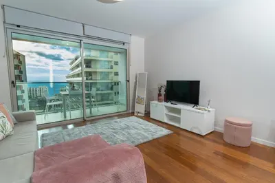 a living room with a couch and a flat screen tv at Alameda Formosa Varanda Zona Turística Funchal in Funchal