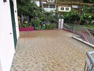 a house with a brick driveway with a garden at Rose house in Ribeira Brava