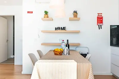 a wooden table with wine glasses and food on it at Villa Bisa II, jacuzzi and sea view in Arco da Calheta