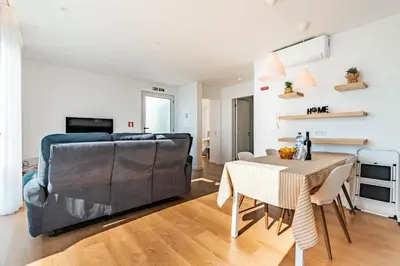 a living room with two chairs and a television at Villa Bisa II, jacuzzi and sea view in Arco da Calheta