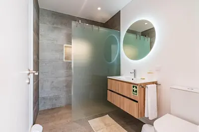 a bathroom with a sink and a mirror at Villa Bisa II, jacuzzi and sea view in Arco da Calheta