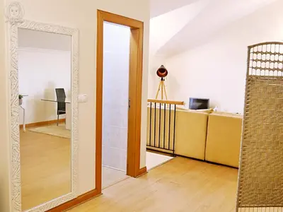 a living room with a mirror and a couch at Dª Xica Holidays in Santa Cruz