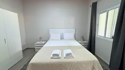 a bedroom with a large bed with two towels on it at Ninho's Sea View By Sam Houses in Ribeira Brava