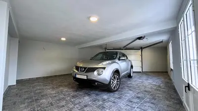 a car parked in a garage with a carport at Ninho's Sea View By Sam Houses in Ribeira Brava