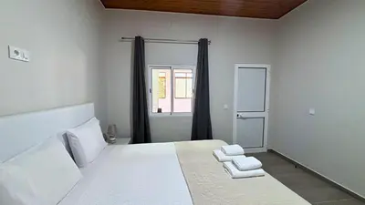 a bedroom with a bed with two towels on it at Ninho's Sea View By Sam Houses in Ribeira Brava