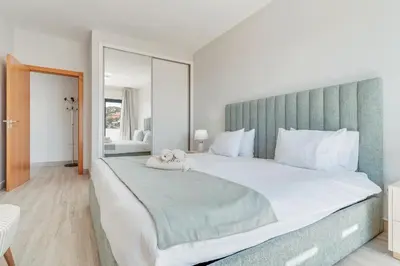 a bedroom with a large bed with a green headboard at Vista Magnífica I by Holiday Rental Madeira in Campanário
