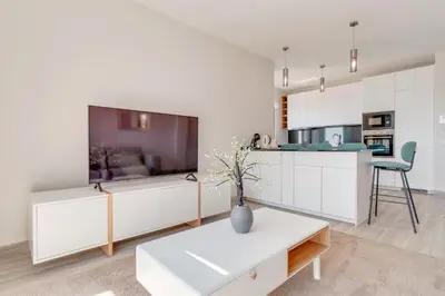 a living room with a large tv and a table at Vista Magnífica I by Holiday Rental Madeira in Campanário