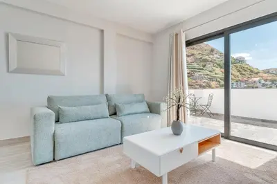 a living room with a couch and a table at Vista Magnífica I by Holiday Rental Madeira in Campanário