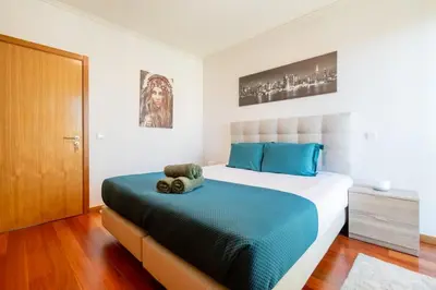 a living room with a tv and a table and chairs at Nomad Horizon Spacious Apartment with Pool & Gym in Funchal