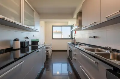 a swimming pool on the roof of a building with buildings at Nomad Horizon Spacious Apartment with Pool & Gym in Funchal