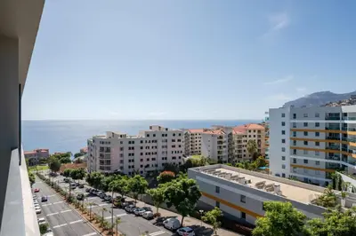 a gym with several tread machines in a room at Nomad Horizon Spacious Apartment with Pool & Gym in Funchal