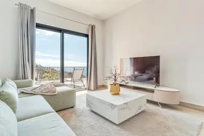 a living room with a tv and a large window at Sonhos na Iha III by Holiday Rental Madeira in Campanário