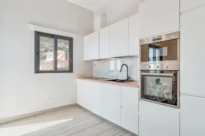 a bedroom with a bed with two towels on it at Alegria Residencial II by Holiday Rental Madeira in Campanário