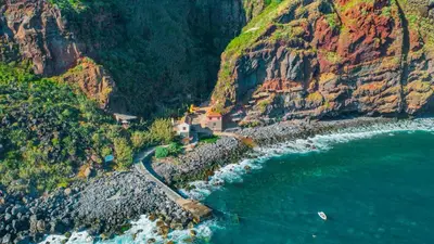 an aerial view of a house on a cliff next to the ocean at Alegria Residencial II by Holiday Rental Madeira in Campanário