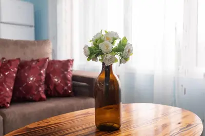 a vase filled with flowers sitting on a table at Casa Vale Sereno by Rent-a-key in Cabo da Ribeira