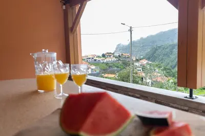 two glasses of orange juice and a plate of watermelon at Casa Vale Sereno by Rent-a-key in Cabo da Ribeira