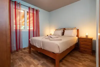 a bedroom with a bed with two candles on it at Casa Vale Sereno by Rent-a-key in Cabo da Ribeira