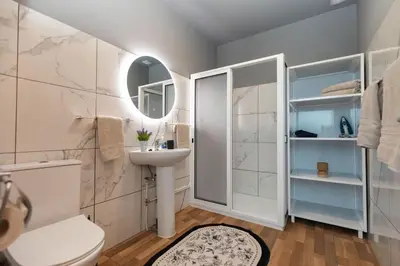 a bathroom with a toilet and a sink and a mirror at Casa Vale Sereno by Rent-a-key in Cabo da Ribeira