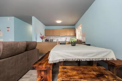 a living room with a table and a couch at Casa Vale Sereno by Rent-a-key in Cabo da Ribeira