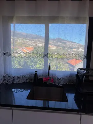 a living room with a couch and a table at Casa da Quinta in Estreito da Calheta