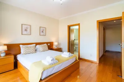 a bedroom with a large bed with towels on it at GuestReady - Relaxing escape with pool in Funchal