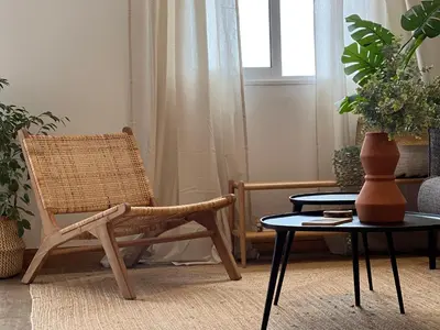 a living room with a chair and a table at Madeira Breeze in Funchal