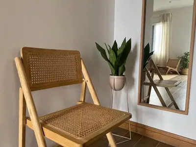 a wooden chair sitting in front of a mirror at Madeira Breeze in Funchal