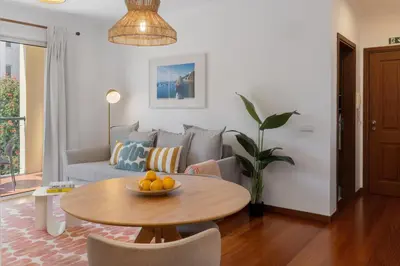 a living room with a table and a couch at Madalenas III by An Island Apart in Funchal