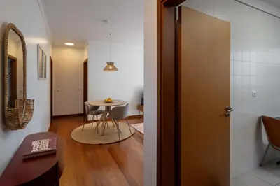a hallway with a small table and a door at Madalenas III by An Island Apart in Funchal