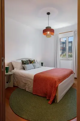 a bedroom with a large bed and a window at Madalenas III by An Island Apart in Funchal