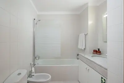 a white bathroom with a toilet and a sink at Madalenas III by An Island Apart in Funchal
