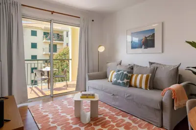 a living room with a couch and a balcony at Madalenas III by An Island Apart in Funchal