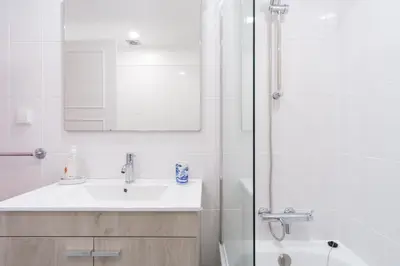 a white bathroom with a sink and a shower at GuestReady - Idyllic vacation with stunning views in Caniço