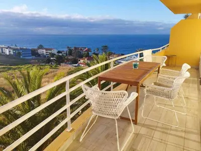 a balcony with a table and chairs and the ocean at Ocean View Terrace by GALMI in Santa Cruz